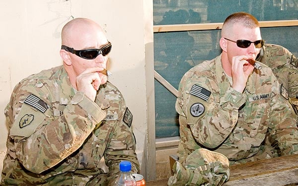 On 06/03/11 during the Kandahar Koughers meeting. CW2 Michael Baber and CW2 Daniel Boggs, 10th Mountain Division, Fort Drum, NY - in support of operations for the Regional Command South, Afghanistan, enjoyed a smoke while talking to the Wounded Warriors. The photo was taken by SGT Jonathan Thomas, 16th Mobile Public Affairs Detachment, Media Support Center. **Kandahar Koughers is an organization started by Alex Medlin that hands out free cigars to soldiers in and around Kandahar Air Field.