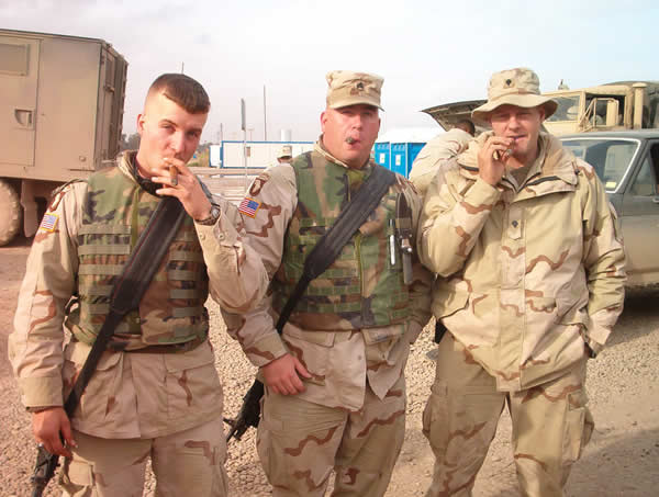 Left to right: Spc. Ricky Boyce, SSG David Dean, and Spc Ron White of 811th Ordnance Company, 548 CSB(10th Mtn. Div), 101 CSG, 101st Abn Div. Enjoying a RyJ #1 at Mosul, Iraq January 2004.