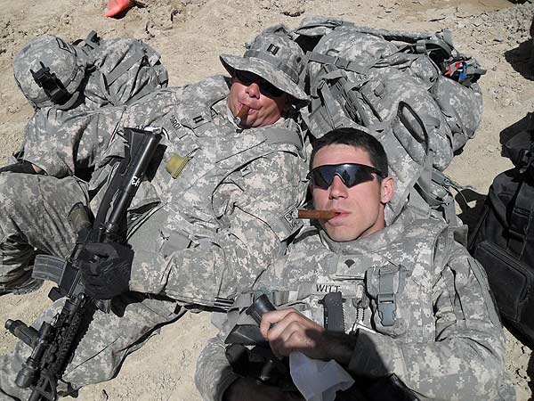 CPT Sgroi and SGT Witt in Afghanistan enjoying a smoke cigar after a long few days.