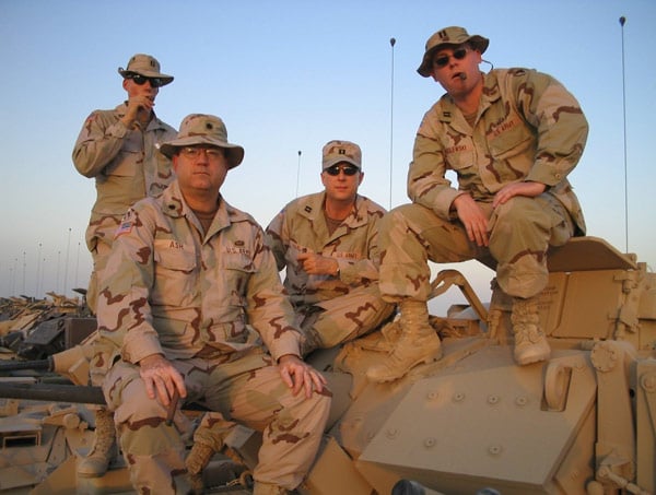 Left to right: CPT Tim Collier, LTC Jeff Ash, CPT Doug Harlan and CPT Jeremy Wasilewski. We are enjoying our Sunday Evening Cigar atop a M2 Bradley fighting vehicle at Camp Arifjan, Kuwait.