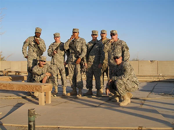 CPT Fishback, 1LT Kalczynski, and Members of the 7SB PSD enjoy a smoke after 1LT Kalczynski&rsquo;s Promotion on top of the Eagle&rsquo;s nest at COB Adder.