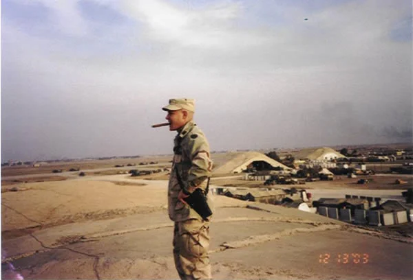 CW2 Jamie Kavanagh smoking a Romeo y Julieta Gran Reserva (Cuban) the day Saddam was captured. Balad, Iraq.