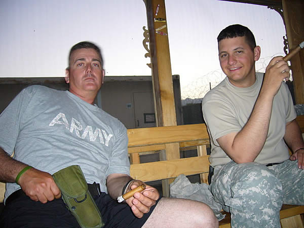 SPC Ben Struebel and his friend Eddie enjoy some cigars in Khost Province, Afganistan.