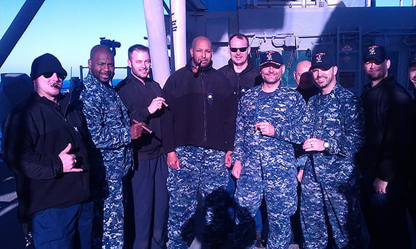 AM1(AW/SW) Nichols (third from right) enjoying a cigar social with the Captain and crew of the USS ESSEX in 2012 in the Pacific ocean. "Love that CI ships to APO/FPO! Thank you for all of your support."