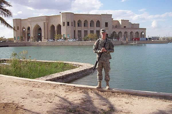 Matthew Werkheiser, son of CI Call Center Sales Rep Terri, stands in front of Al Faw in Iraq.