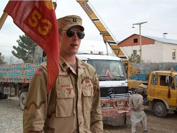 The commander of the 53rd supervising the emplacement of concrete barriers around his compound.