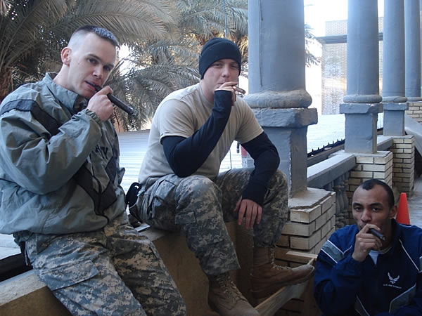 From left to right: SPC McWherter, SPC Mann and SrA Norwood enjoy CAO and Bohemian cigars while stationed in Baghdad, Iraq.