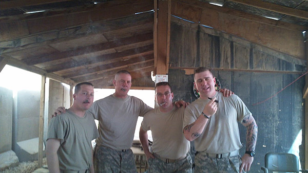 From Left to right: SPC Bohne, 1SG Thompson, CW2 Melanson, SGT Smith. Soldiers of E Btry (TA) 101st FA enjoying some cigars from CI with their first Sergeant in Iraq.