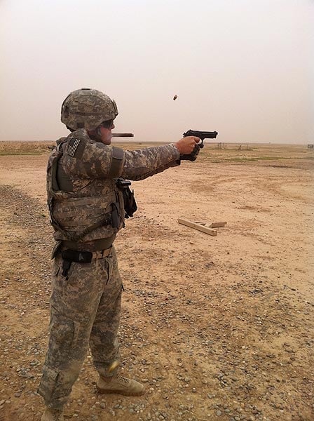 SPC Dustin &rsquo;MAC&rsquo; McAnulty at the range in Iraq at COB Spiecher shooting an M9 service pistol and enjoying a Gurkha Silver Edition. "Thanks CI!!!"