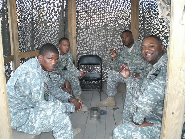 SGT Turner, SPC Burris, SFC Townsend, and CW2 McNorton relaxing in their smoking area at Camp Liberty, Iraq 24 Aug 07.
