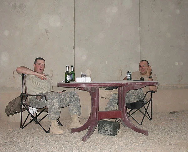 CPT Curt Keppeler and SFC Paul Salinas III enjoying smokes and near-beers at COB Speicher, Iraq.