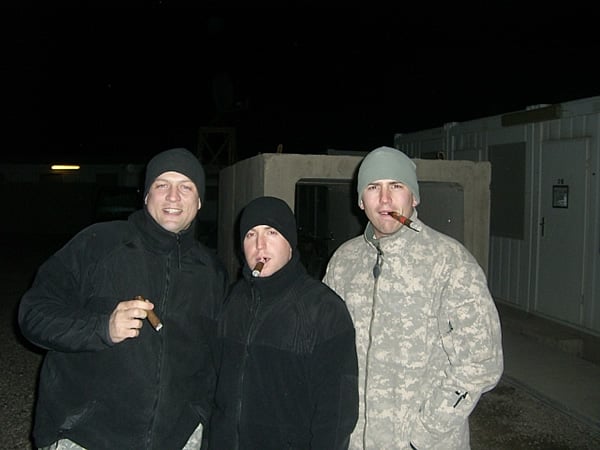 From left to right: CPT Lynn, 1LT Stockton and CPT Woodward enjoying cigars on Super Bowl night while stationed in Iraq.