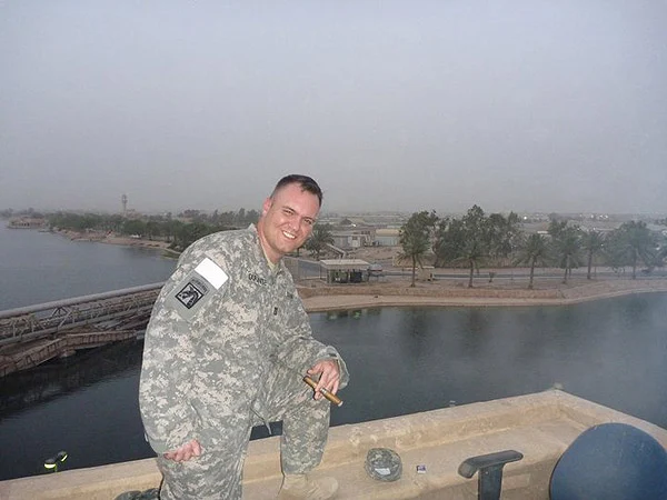 CPT Craig Durante enjoying the smell of victory (Ghurka Beauty) on the roof of the enemy commander&rsquo;s palace in the evening (Iraq).