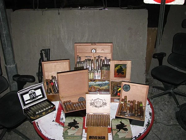 The USFOR-A / NKC 1165th Military Police, stationed in Afghanistan. "Here are some pictures of my fellow Soldiers, friends, and myself enjoying the wonderful cigars that you sell."