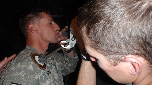 SGT Max is a Flight Medic of C Co 1/189th GSAB MEDEVAC unit currently in Iraq participating in &rsquo;the branding&rsquo; (a new unit tradition) while enjoying an Acid Deep Dish.