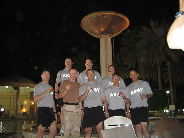CPT Dan Rhon and others of the 4th Infantry Division standing in a group in front of Sadam&rsquo;s Pool.