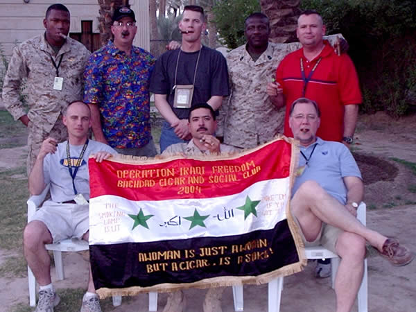 Members of the Coalition Provisional Authority gather in back of Saddam&rsquo;s pool to enjoy an evening smoke. Pictured are (Sitting): Chief Petty Officer Vince Sievers, USN, Senior Chief Petty Officer Jose Serna, Mr. Kurt Reineke, Vinnell Corporation (Standing): Captain Galen James, USMC, Technical Sergeant Doug Huffines, USAF, Lieutenant Shane Rice, USN, First Sergeant Ray Fullard, USMC, Chief Petty Officer Dave Braddock, USN.