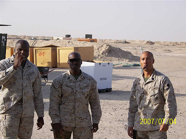 3 Staff Noncommissioned Officers from 2D Maintenance Battalion Supply Company enjoying cigars from CI on the 4th of July. Sent by 1stSgt C.L. Edmondson.