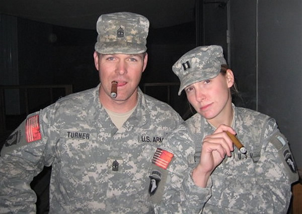 From left to right: 1SG Turner and CPT Ussery enjoy a cigar while on duty in Iraq.