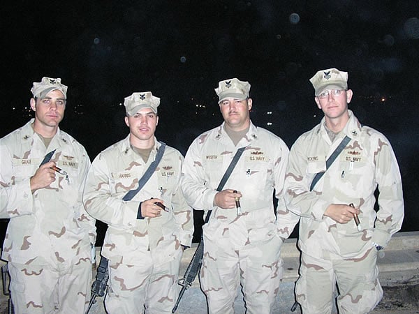 From left to right: AT1 Richie Grau, FT1 Erich Harris, STG1 Joe Wester, and FC1 Drew Pickens from Task Force Hurricane enjoy some cigars from the 3rd story balcony of Al Faw Palace at Camp Victory in Baghdad.
