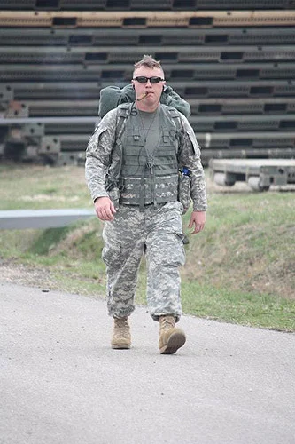 A soldier during the final 100m of the DANCON March. The DANCON (Danish Contingent) march is a 26km (16 mi) marched that must be done in less than eight hours with a 10kg (22 lbs) load. The cigar is a CI Legend, Copper Label.