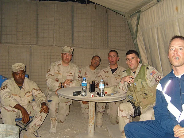 Some Airmen in stationed at an undisclosed location overseas enjoy a Smoke Pit meeting with cigars from CI.