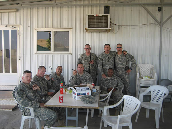 The guys from the Devil Strike Cigar Club enjoying smokes at Ciano&rsquo;s in LSA Adder, Iraq.