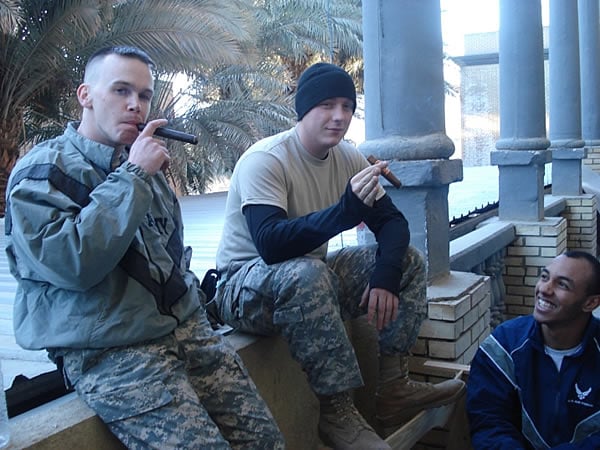 From left to right: SPC McWherter, SPC Mann and SrA Norwood enjoy CAO and Bohemian cigars while stationed in Baghdad, Iraq.