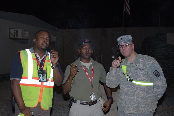 Mark Randal and SPC Soto are enjoying some fine cigars from CI in Iraq. "Thanks CI."