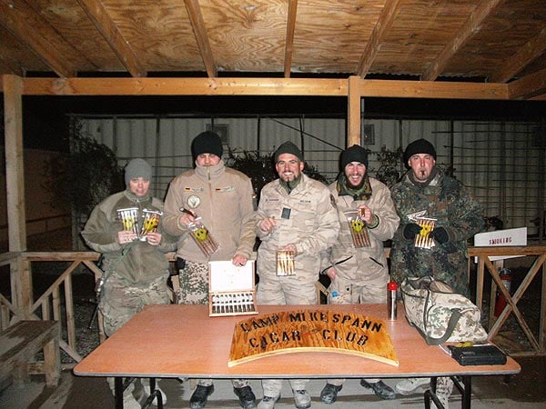 The "CAMP MIKE SPANN CIGAR CLUB" in Afghanistan. "Every Friday we have a multinational meeting and enjoy the cigars from Cigars International."
