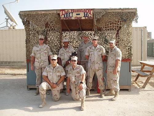 Pictured here standing in front of Camp Patriot&rsquo;s "The Humidor", (a cigar only smoking shack) left to right, are: EN2 Krohne, OSC Vieyra,SK3 Anderson, IT1 Weber, TM2 Smith, GM2 Brabeck & EN2 LeBron.